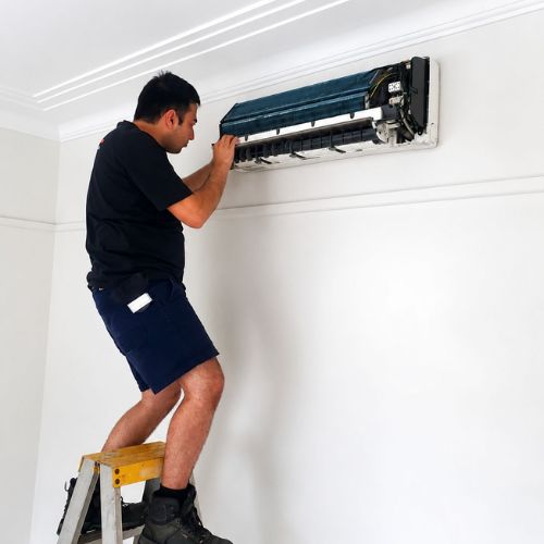 Air Conditioning Repairs Sydney - technician repairing AC unit