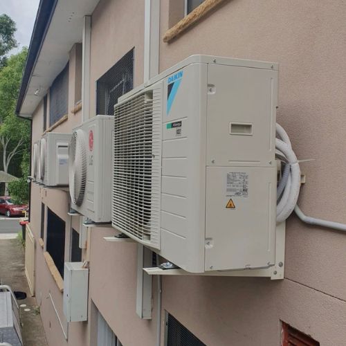 Split System Installation Sydney - technician installing split air conditioner