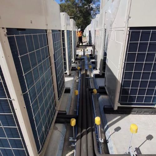Air Conditioning Maintenance - technician servicing AC unit